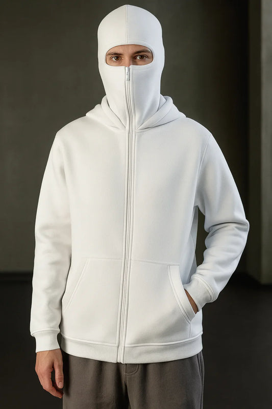 Person wearing a white full-zip hoodie with built-in face cover, urban streetwear style