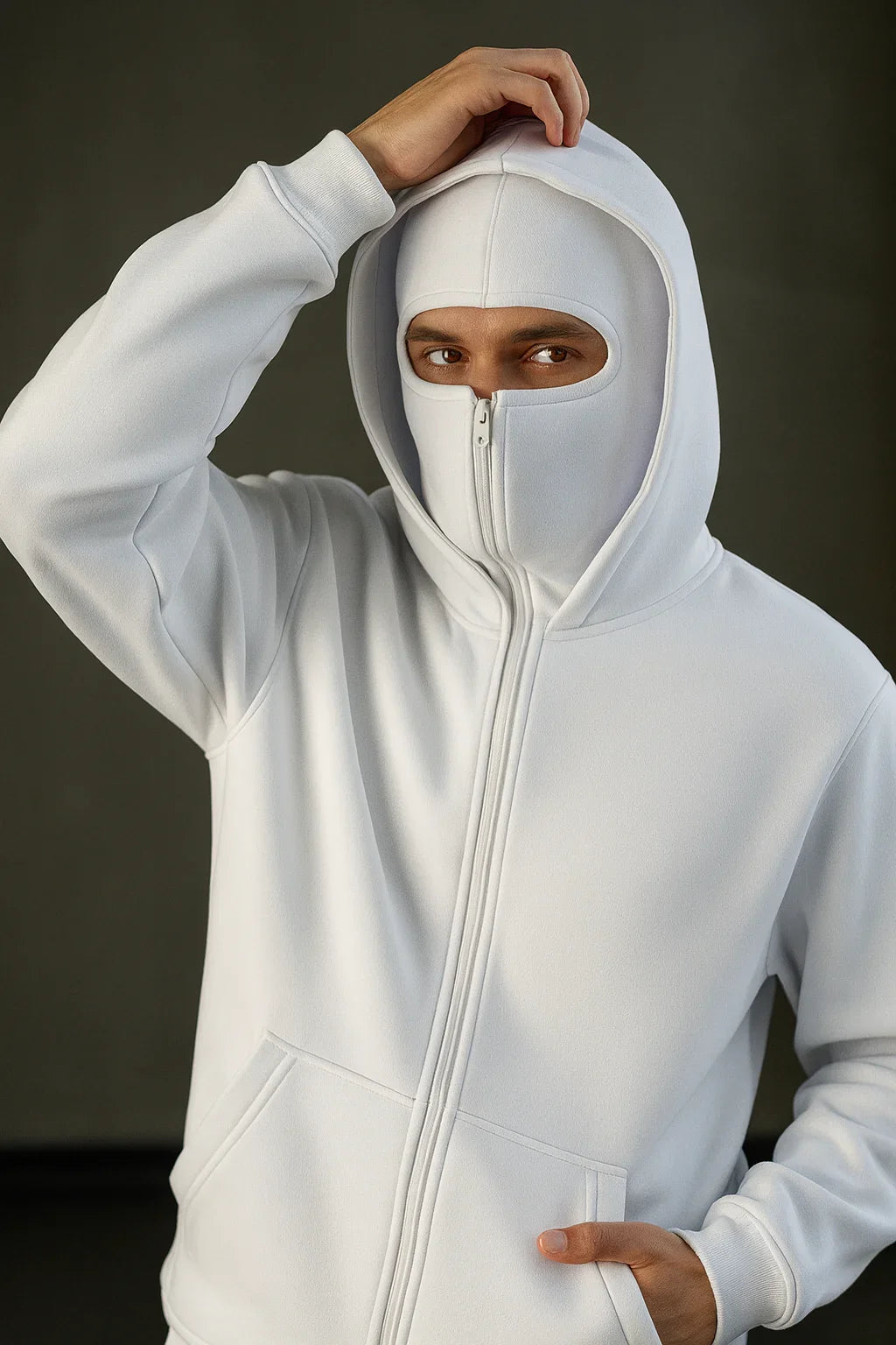 Man in white oversized zip-up hoodie with built-in face cover, streetwear fashion