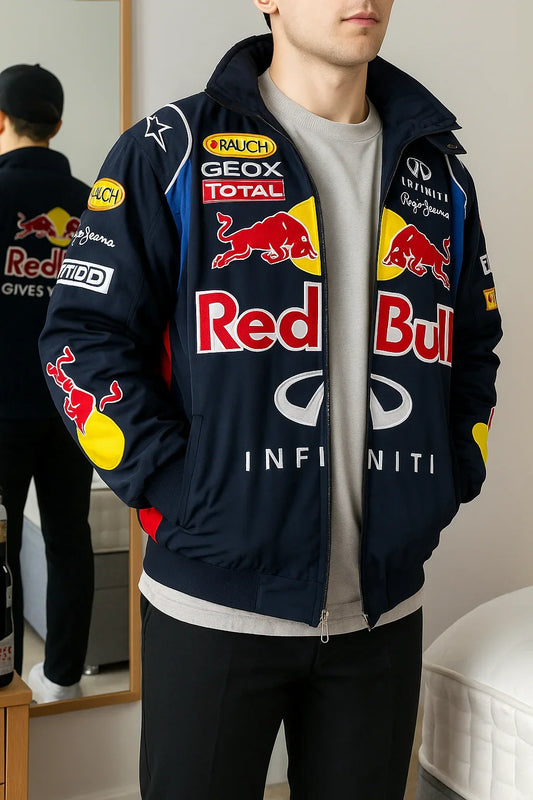Man wearing a navy oversized streetwear jacket with bold racing-inspired patches and logos