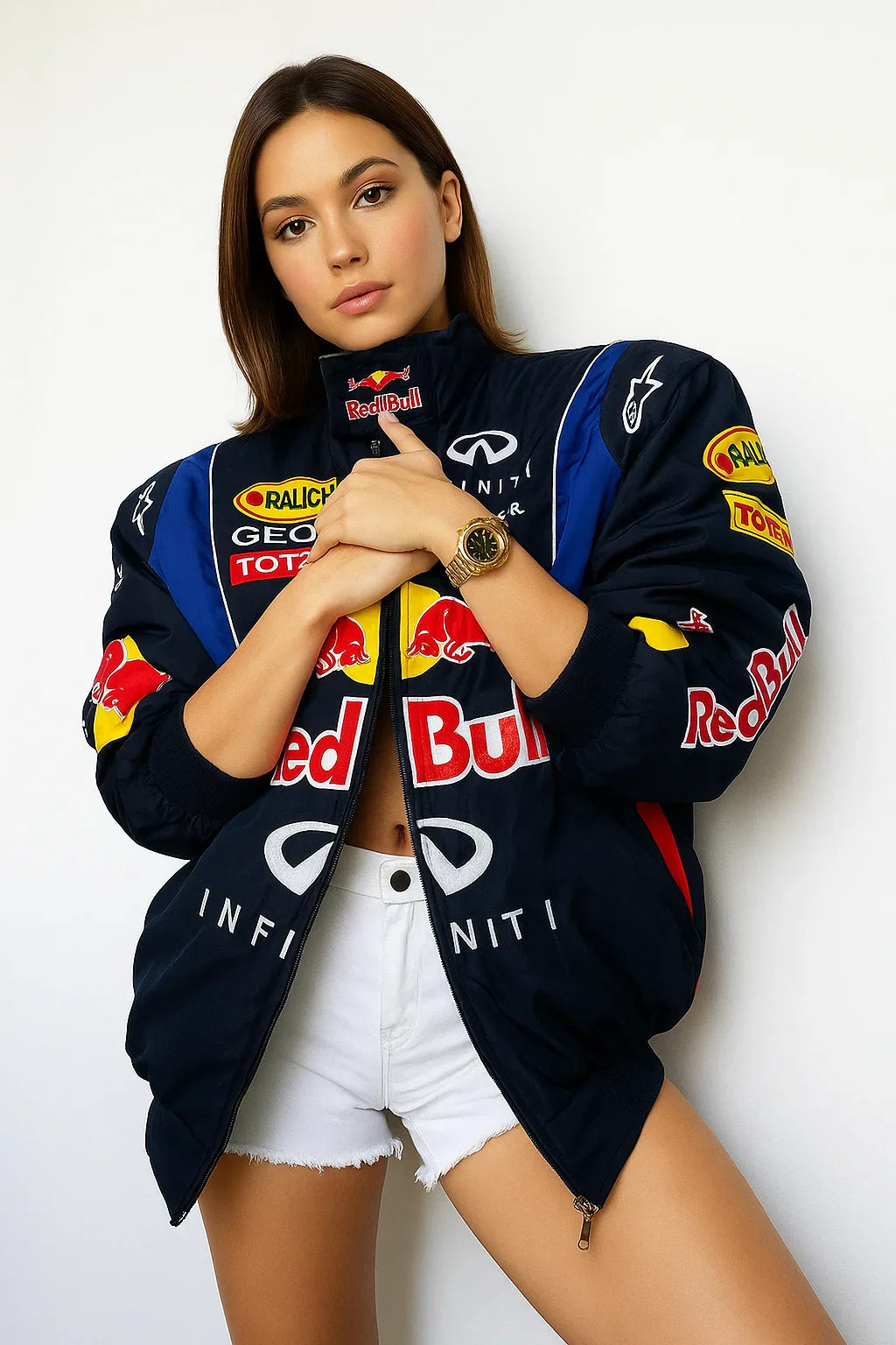 Woman in oversized racing bomber jacket with colorful patches and white shorts, urban streetwear style