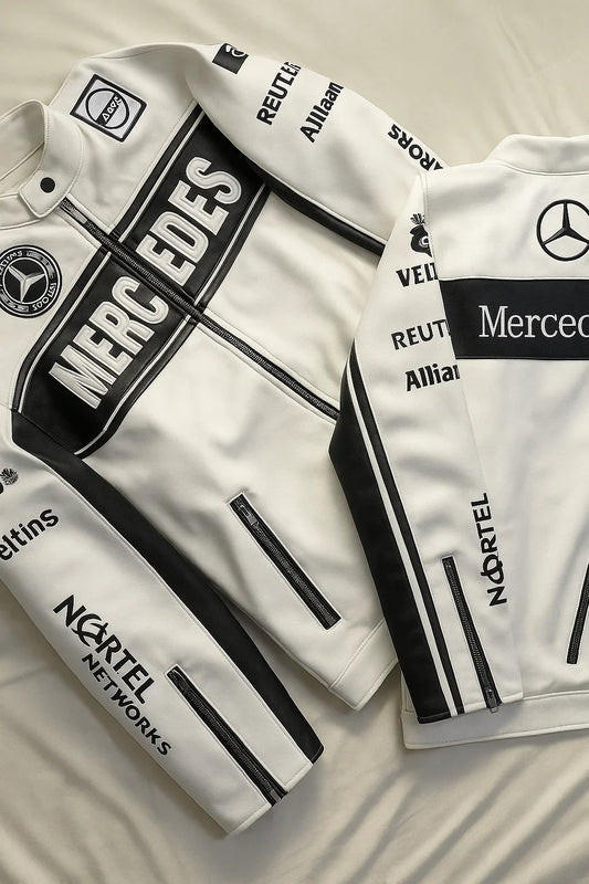 White streetwear jackets with black racing stripes and Mercedes logos, laid on a bed.